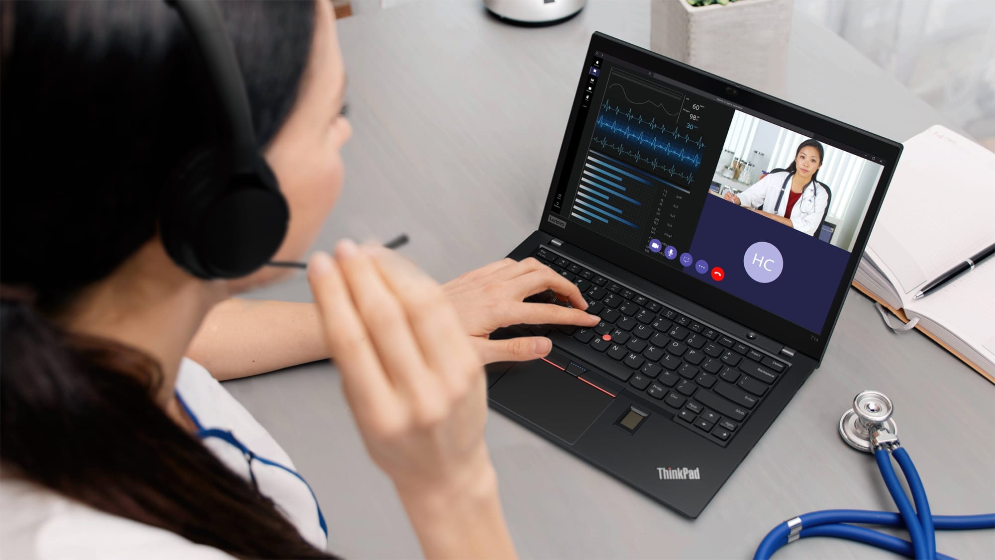 A doctor having a video chat with her colleague using a ThinkPad laptop