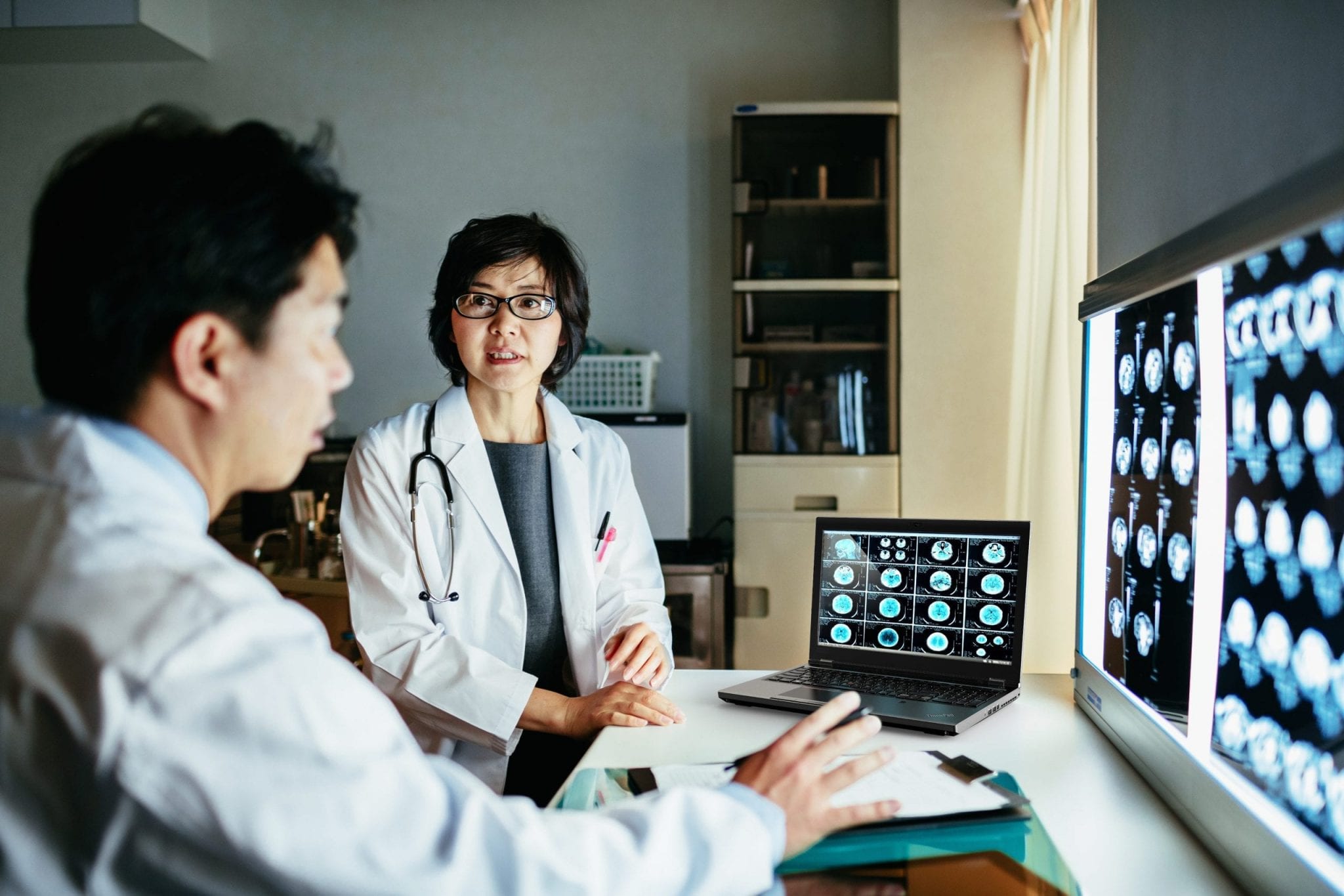 Doctor and a Radiologist analyzing the result of a brain scan