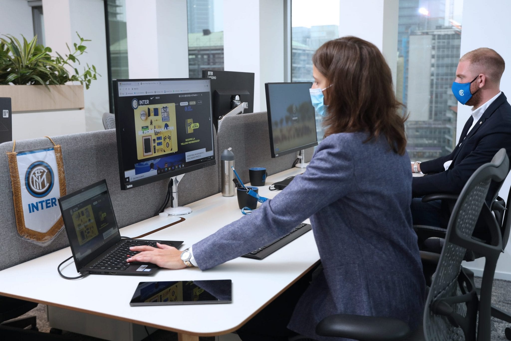 An FC Inter employee working on Lenovo devices