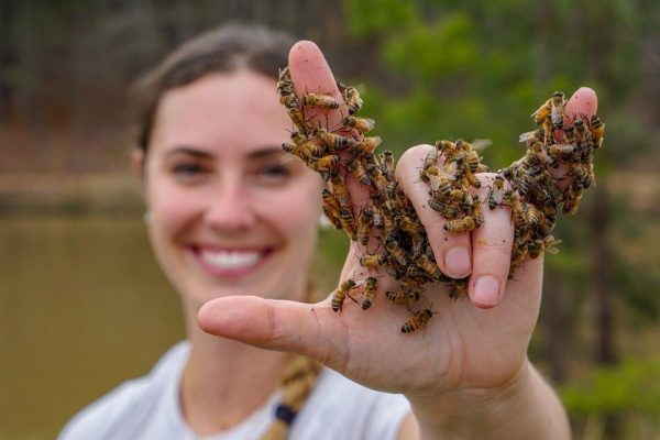 Leigh-Kathryn holding bees in her hand.